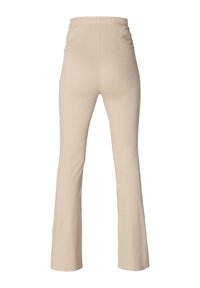 Beige uitlopende broek gemaakt van rekbare stof, met een elastische tailleband en een gladde textuur, met een aansluitende pasvorm tot aan de knieën.