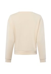 Felpa a girocollo in beige chiaro, texture morbida, lunghezza leggermente accorciata, polsini e orlo a coste, senza grafiche o decorazioni visibili.