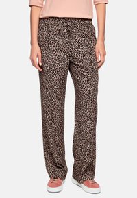 Leopard print pants made of soft fabric with an elastic waistband and drawstring. Loose fit and wide leg style, paired with pink shoes.