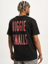 Black cotton t-shirt featuring large red text on the back reading "BIGGIE SMALLS." Short sleeves and a relaxed fit.