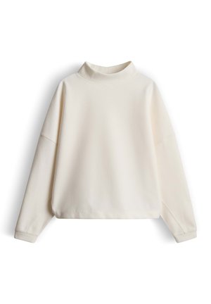 Felpa color crema con collo alto, spalle scese e maniche lunghe. Realizzata in tessuto morbido e strutturato con una vestibilità rilassata.