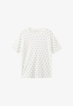 Chemise blanche à manches courtes avec des pois noirs, un col rond et un ourlet droit.