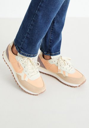 Lightweight sneakers in peach and cream tones, featuring suede and mesh material, lace-up design, and rubber sole with traction.