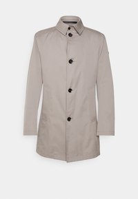 Giacca beige realizzata in tessuto liscio, con colletto a punta, chiusura frontale con bottoni e due tasche laterali. Design minimalista senza motivi.