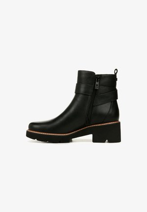 Black ankle boot made of leather with a side zipper, stacked heel, textured finish, and two horizontal straps for added detail.