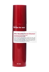 Rote zylindrische Flasche mit glatter Oberfläche, beschriftet mit "Ultra Sensitiver Gesichtsreiniger", mit weißem Text. Der Deckel ergänzt die elegante Form.