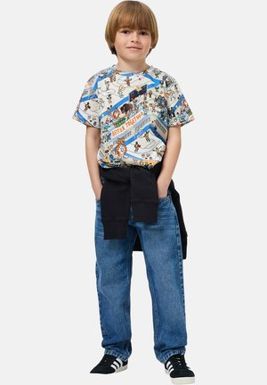 Grafisch T-shirt met kleurrijke cartoonfiguren, een blauwe rand en de tekst "BETTER TOGETHER". Gecombineerd met loszittende blauwe spijkerbroeken en een zwarte trui.