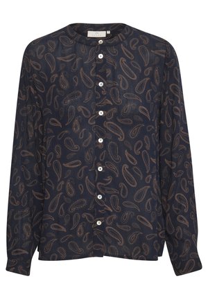 Mørk marinebluse med brune paisley-mønstre, rund krave, lange ærmer og syv hvide knapper ned foran i midten.