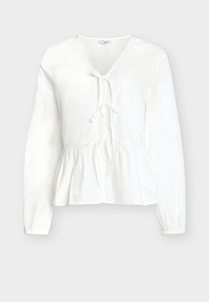 White long-sleeve women's blouse with V-neck, front tie closures, and gathered peplum hem, displayed against a plain background.