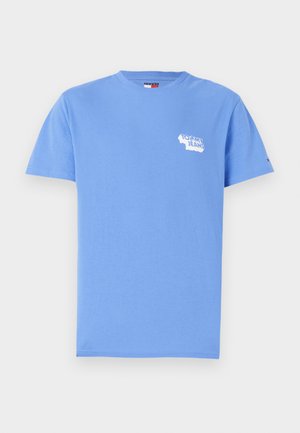 T-shirt en coton bleu à manches courtes, col rond, affichant un logo "Tommy Jeans" blanc sur la poitrine gauche et un petit logo sur la manche droite.