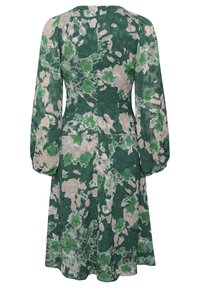 Robe à motifs floraux avec des manches longues. Teintes vertes et beiges, texture légère, silhouette en A et fermeture par zip au dos.
