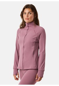 Light purple zip-up jacket with a high collar, long sleeves, and fitted design. Features side pockets and ribbed cuffs for added comfort.