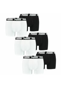 Black and white boxer briefs with branded elastic waistbands. The fabric appears smooth, and the design is form-fitting with a classic style.