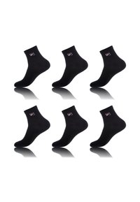 Chaussettes de cheville en mélange coton noir, avec une bordure côtelée et un logo sur chaque chaussette. Pack de six avec une texture lisse et une ombre réfléchissante.