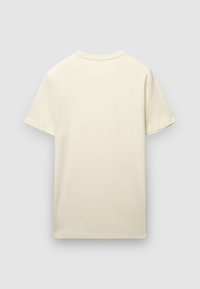 T-shirt à manches courtes de couleur crème clair, fabriqué en coton doux, avec un col rond et une coupe décontractée, sans motifs ni accents.