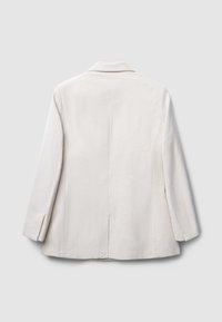 Blazer en velours côtelé beige clair avec un col cranté, une fente au dos et des manches longues, présentant une texture côtelée et des détails de couture soignés.