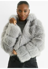 Gray faux fur jacket with a hood, zip closure, puffy sleeves, and textured detailing. Worn over a ribbed gray top and black pants.