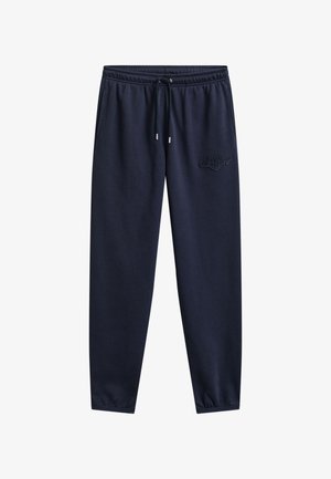 Laivastonsiniset collegehousut, joissa on joustava vyötärönauha, nyöri, sivutaskut, kapeat lahkeet ja hillitty kirjailtu logo oikeassa reisessä.