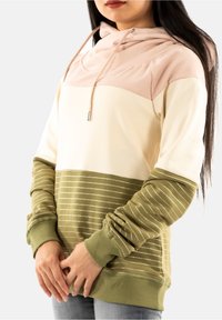 Sweat à capuche en crème, rose et vert olive. Présente des rayures horizontales dorées sur la partie inférieure. Tissu doux, coupe décontractée.