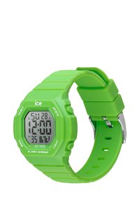 Orologio digitale brillante verde che mostra l'ora, la data e le funzionalità di allarme, con un cinturino in gomma e una fibbia in metallo.