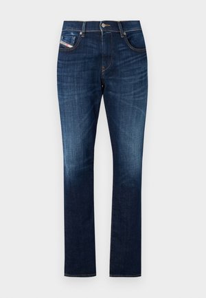 Temno modri jeansi iz denima s ravnim krojem, zasnovo s petimi žepi, subtilnim zbledelostmi in kontrastnim šivanjem ob šivih.