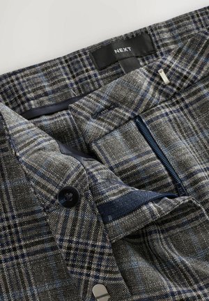 Grey and blue plaid trousers with a button closure, zipper pocket, and textured fabric. Features inside lining and brand label.