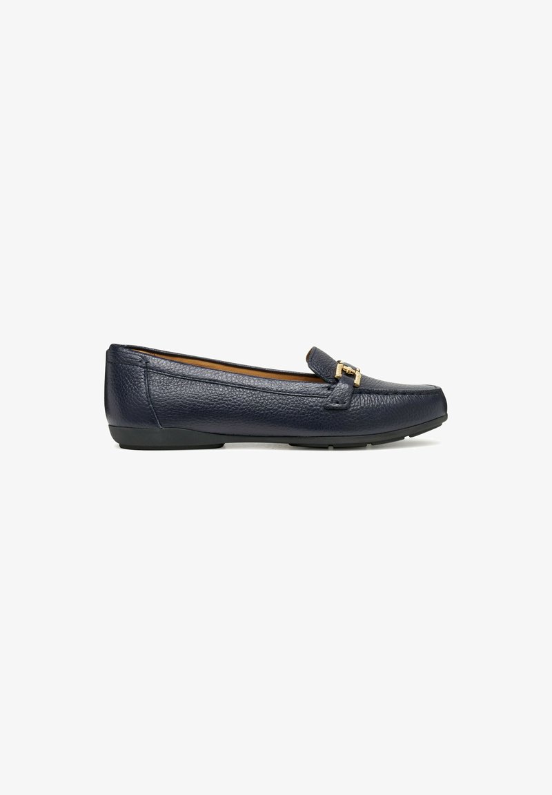 Mocasines de cuero azul marino con un detalle de hebilla dorada y una suela negra baja, posicionados para mostrar el perfil lateral del zapato.