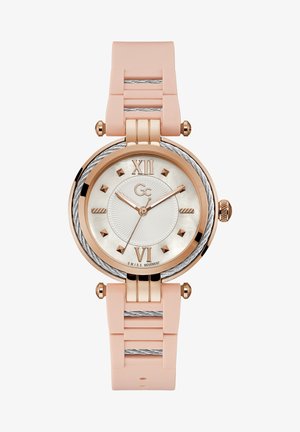 Ümmargune kell roosi kullast korpusega, valge pärlmutterist kellapaneel, roosa silikoonist rihm ja hõbedased detailid. Märgid 12. ja 6. kohal.