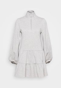 Robe gris clair à manches longues avec col montant et fermeture éclair argentée sur le devant, présentant des volants froncés et des poignets élastiques aux manches.