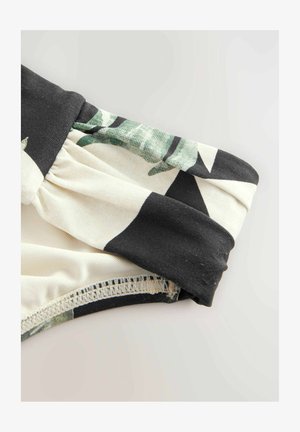 Îmbrăcăminte din țesătură cu model floral, având un elastic negru strâns în talie, cu nuanțe fine de crem și verde și o textură netedă.