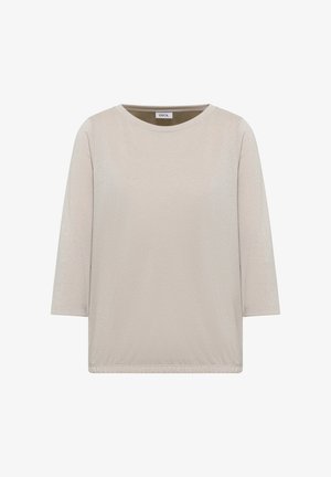 Ljusbeige topp med trekvartsärmar, rund halsringning och subtil struktur. Har en elastisk nederkant för en avslappnad passform. Inga mönster eller detaljer.