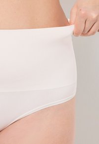 Weiße Stretch-Cotton-Slips mit glatter Textur, breitem Bündchen und nahtlosem Design an den Beinöffnungen.
