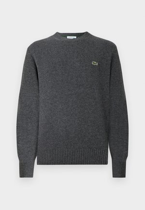 Gray knit sweater with a round neckline, ribbed cuffs and hem. Features a small green Lacoste logo on the chest. Soft texture.