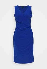 Royal blue sleeveless dress with a wrapped front design, gathered sides, and a knee-length fit made from soft, stretchy fabric.