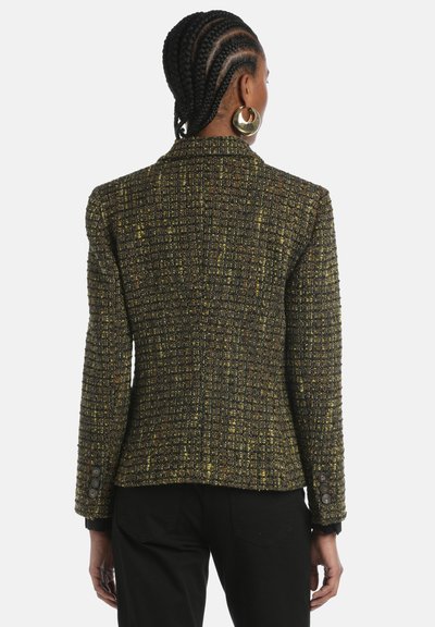 Tweed blazer in dark green and yellow with a textured pattern, fitted shape, notched lapels, and buttoned cuffs.