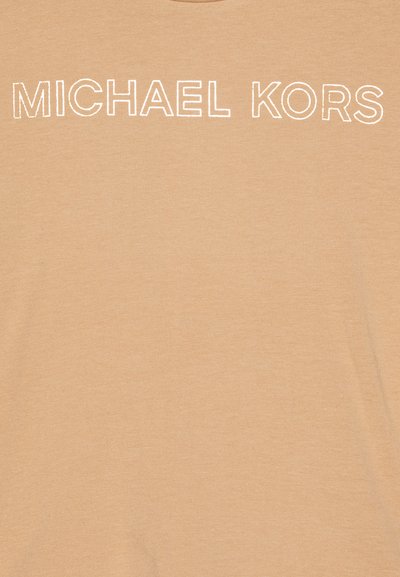 Beige cotton t-shirt featuring "MICHAEL KORS" logo in white, rounded neckline, short sleeves, and a smooth, soft texture.