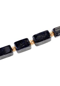 Naszyjnik z koralików z prostokątnymi, ciemnoniebieskimi kamieniami szlachetnymi z błyskami, przerywany małymi, okrągłymi koralikami w kolorze złotym.