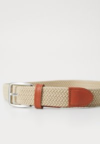 Woven beige belt with a textured finish, featuring a silver metal buckle and brown leather accents.