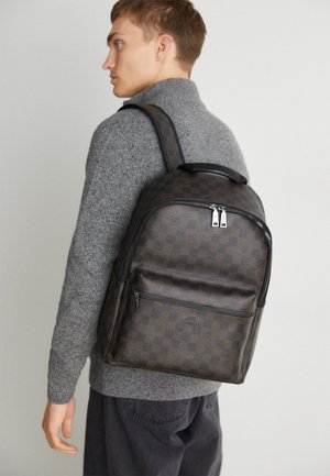 Bőr hatású, texturált bőrből készült barna, mintás hátizsák, elülső cipzáras zsebbel, dupla vállpánttal és felső fogantyúval.