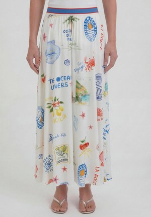 White skirt with colorful seaside-themed prints including palm trees, crabs, lemons, cherries, seashells, and travel stamps.