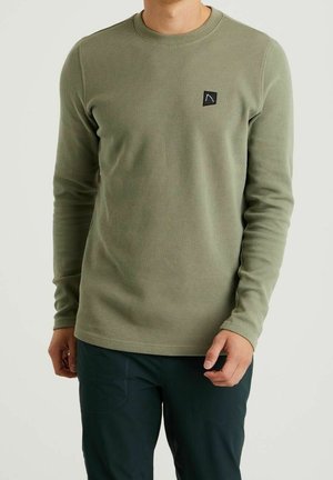 Groen thermoshirt met lange mouwen, voorzien van een gemarmerd, geribbeld patroon en een klein zwart logo op de linkerborst. Gladde, aansluitende mouwen.
