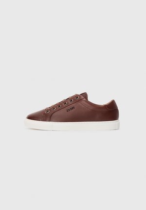 Brown leather low-top sneaker with white sole, metal eyelets, and embossed "JOOP!" logo on the side, viewed from the outer side.