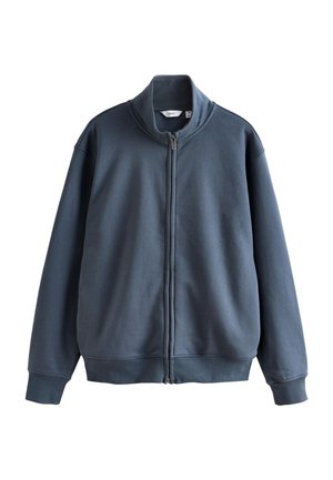 Tamsiai mėlynas megztinis su aukštu apykakliu, pilnu priekiu su užtrauktuku, ilgomis rankovėmis, elastingomis rankogaliais ir lygiu paviršiumi.