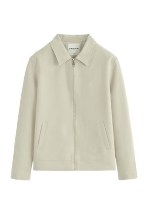 Veste beige clair zippée avec col et deux poches avant, manches longues et design épuré et minimaliste.