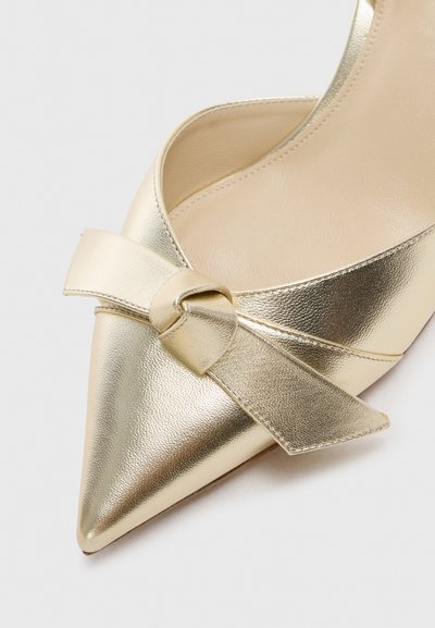 Gold metallic high-heeled shoe with a pointed toe, featuring a knotted ribbon detail on the front and a smooth, glossy finish.