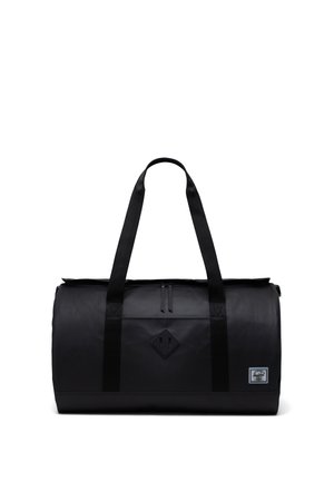 Black duffel bag made of durable material, featuring sturdy shoulder straps, a zippered top, and a diamond logo patch on the front.