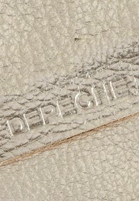 Light grey leather with a textured, wrinkled surface. Features embossed lettering "DEPECHE" on a horizontal band across the material.