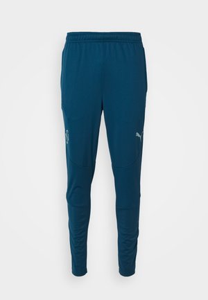 Dunkelblaue Sporthose aus atmungsaktivem Material, mit enger Passform, elastischem Bund und reflektierendem Logo auf dem linken Oberschenkel.