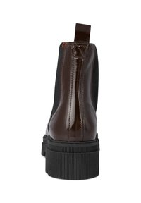 Brown patent leather ankle boot with elastic side inserts, textured black rubber sole, and a pull tab at the back for easy wear.