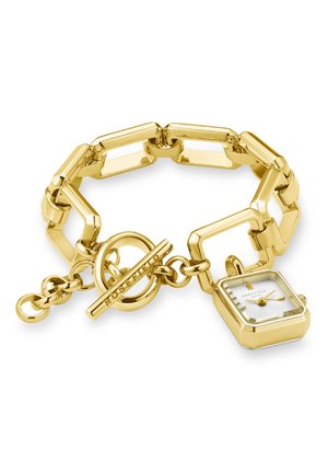 Montre-bracelet dorée avec des maillons rectangulaires, un cadran blanc et des accents dorés. Elle dispose d'un fermoir à bascule avec le nom de la marque gravé.